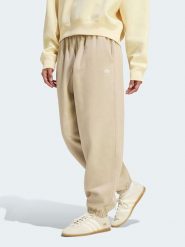Adidas Spodnie dresowe w kolorze beżowym rozmiar: M. Brązowe spodnie dresowe adidas, bez wzorów, z dresówki. Za 209.95 zł.