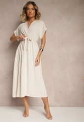 Jasnobeżowa Rozkloszowana Sukienka z Gumką w Talii i Wiązaniem Sepenira. Brązowe sukienki Renee, na co dzień, xs, bez wzorów, z jeansu, eleganckie, bez kołnierzyka, bez ramiączek, maxi, kopertowe. W wyprzedaży za 63.99 zł.