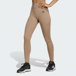 Legginsy 7/8 bez szwu z przodu Optime Essentials. Brązowe legginsy adidas, bez wzorów, sportowe. W wyprzedaży za 135.78 zł.
