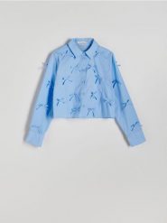 Krótka koszula z kokardkami - niebieski. Niebieskie koszule Reserved, l, bez wzorów, z bawełny, bez kołnierzyka, bez ramiączek. W wyprzedaży za 65.99 zł.