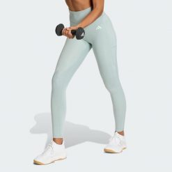 Długie legginsy Optimé Essentials Stash Pocket. Zielone legginsy adidas, bez wzorów, długie. Za 199.00 zł.