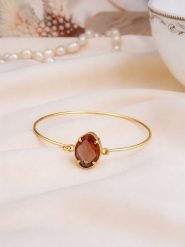 Pierres de Jade Pozłacana bransoletka z cyrkonią rozmiar: onesize. Brązowe bransoletki Pierres de Jade, z cyrkonią, pozłacane. Za 45.45 zł.