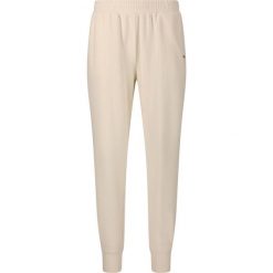 Damskie spodnie dresowe Athlecia Hecey. Białe spodnie dresowe Athlecia, bez wzorów, z dresówki. Za 195.00 zł.