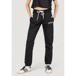 Spodnie Kobieta ICON. Czarne spodnie dresowe ICON, bez wzorów, długie. W wyprzedaży za 292.40 zł.